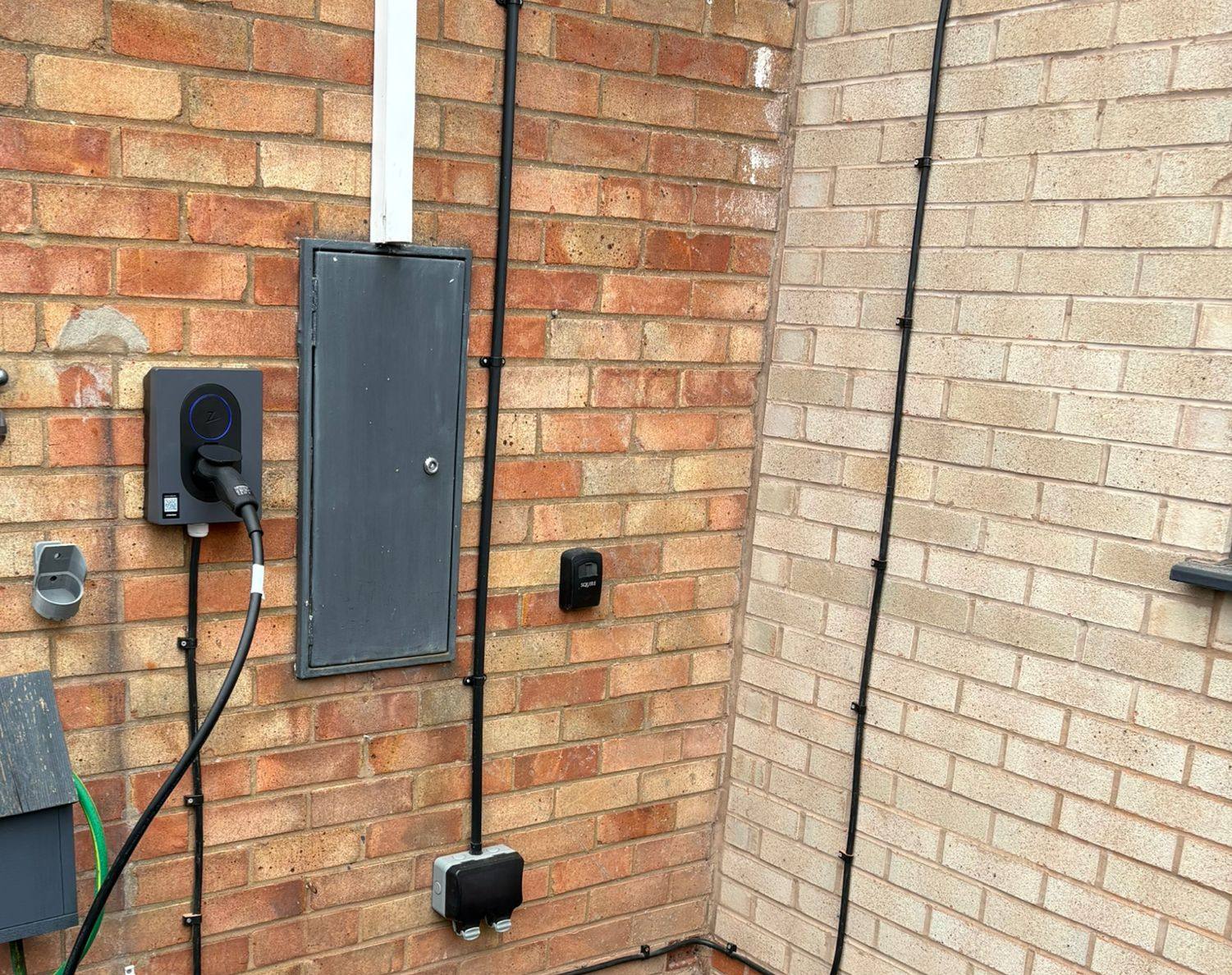 Zappi EV charge point installed with tidy cable runs on a customer home